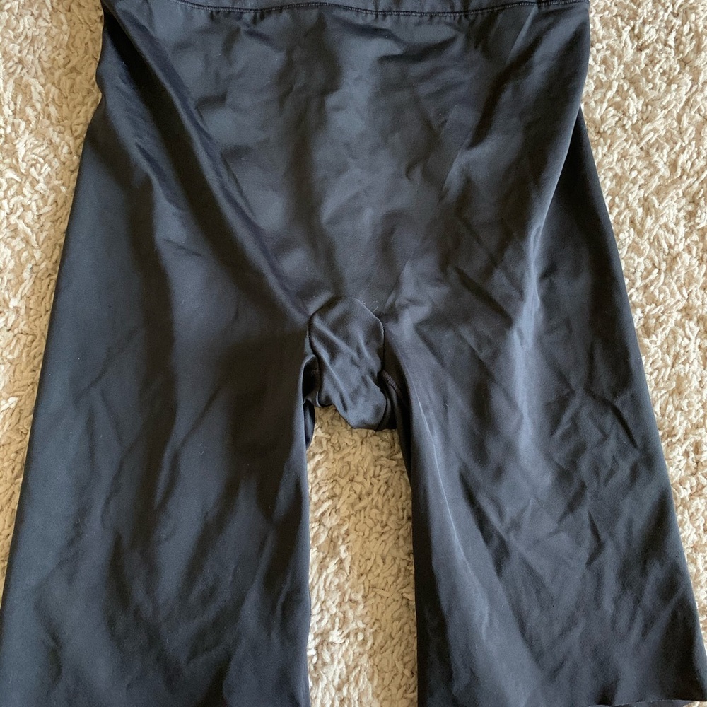 Black, slick material like, biker shorts